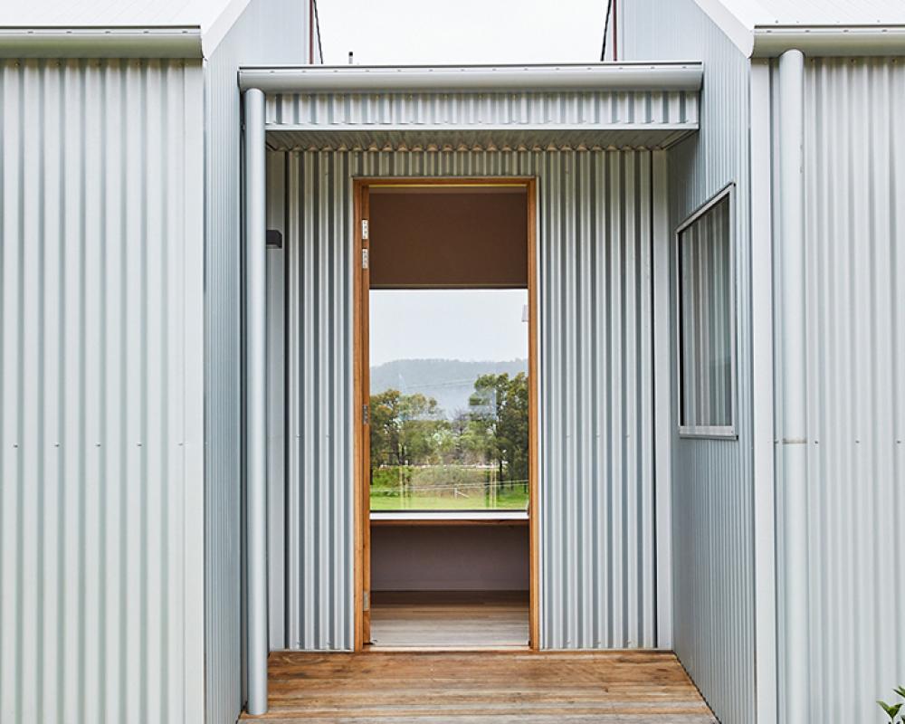 Light grey COLORBOND® steel cladding in corrugated profile with timber.