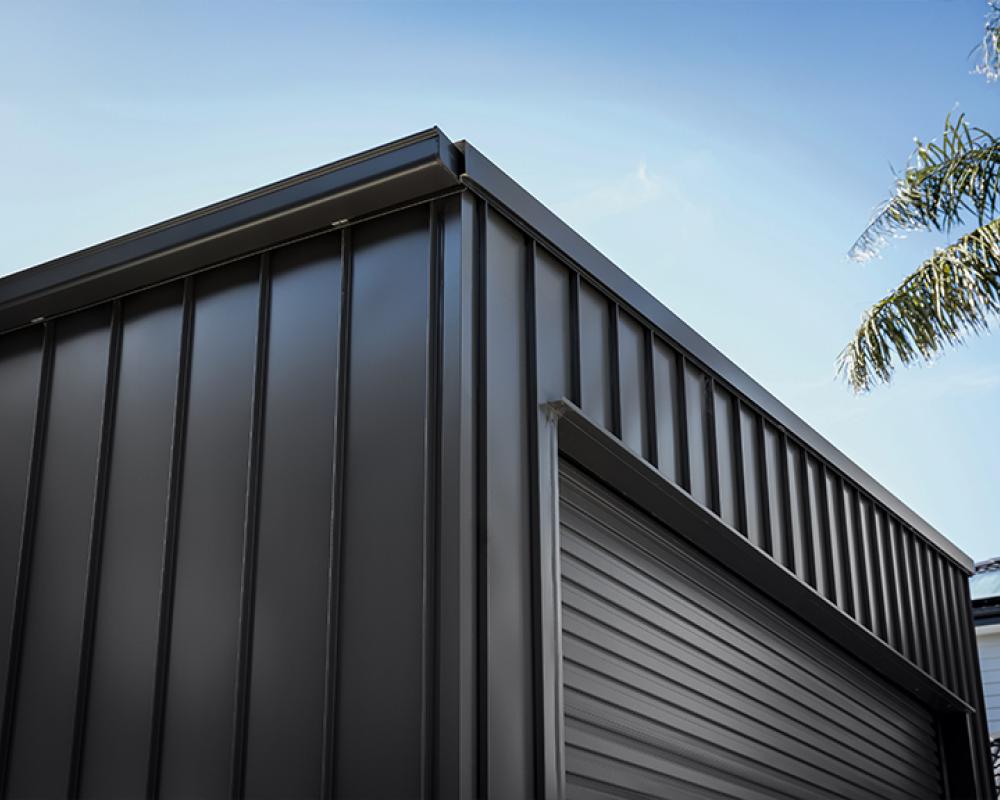 Close-up of modern garage with vertical COLORBOND® steel cladding profiles and sharp architectural lines.