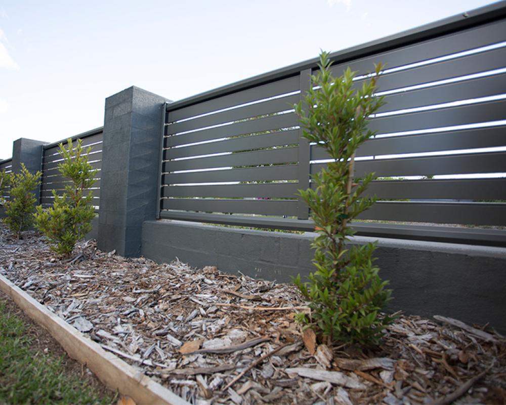 Low maintenance fencing with horizontal slat screen panels for stylish garden privacy