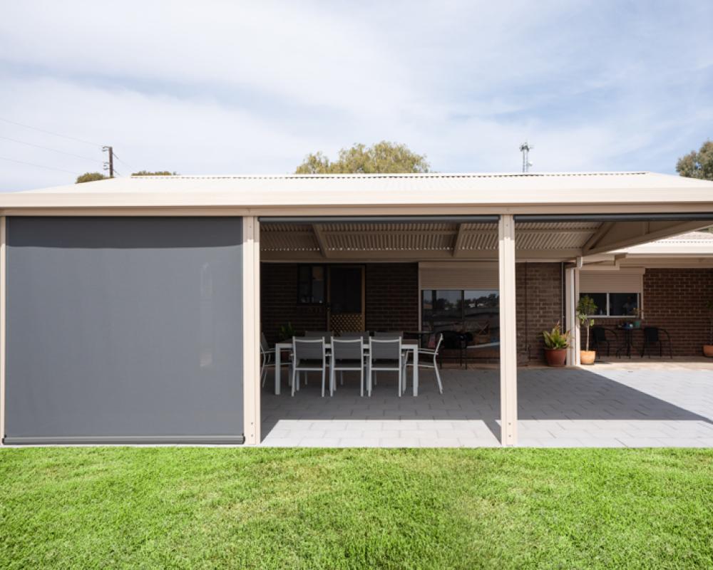 Flat roof patio with outdoor dining area and shade screen designed for easy patio maintenance