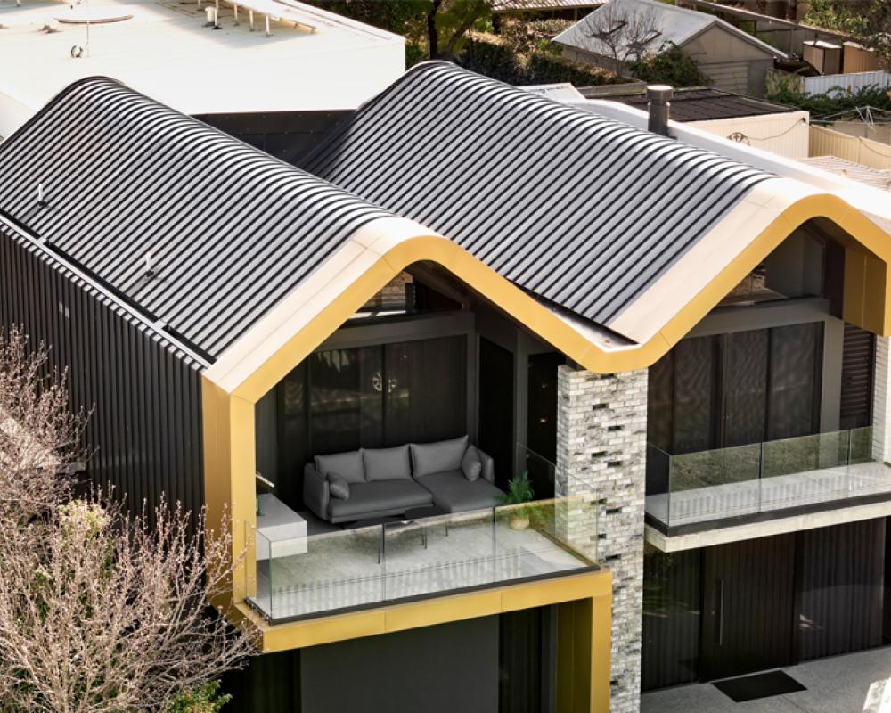 Contemporary multi level home with curved rooflines highlighting varied COLORBOND® steel roofing profiles