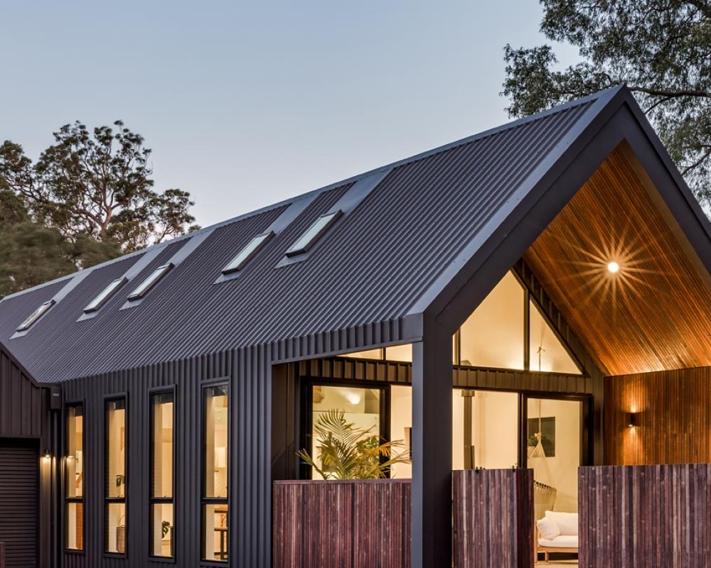 Modern home with dark COLORBOND® steel roofing and wall cladding, showing how roofing colour defines contemporary design