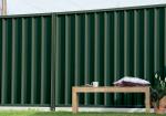Low maintenance fencing in deep green COLORBOND® steel colour with garden seating