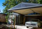 Residential carport with steel roof and posts, showing coordinated COLORBOND® colours and sheltered parking beside a home