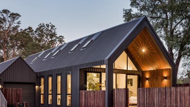 Modern home with dark COLORBOND® steel roofing and wall cladding, showing how roofing colour defines contemporary design