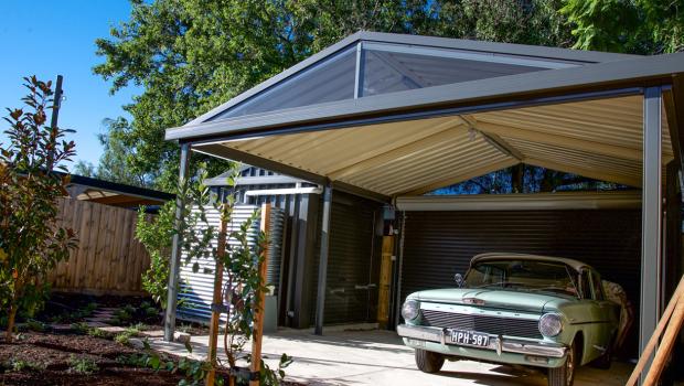 Residential carport with steel roof and posts, showing coordinated COLORBOND® colours and sheltered parking beside a home