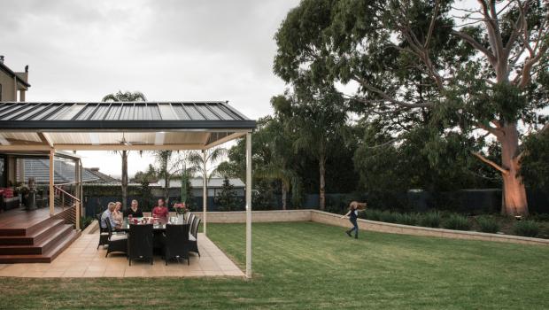 Patio designed for indoor-outdoor living with outdoor dining area and seamless connection to the backyard