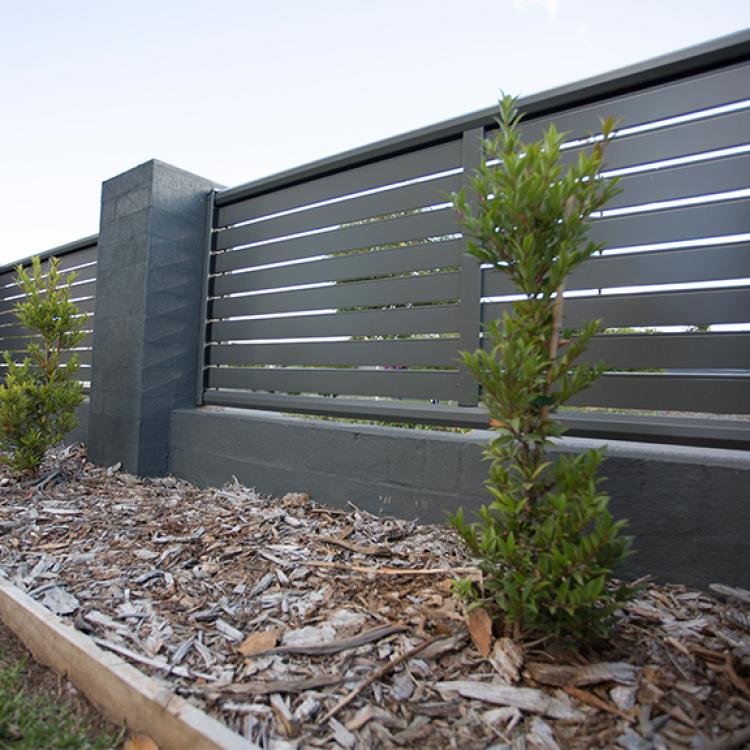 Low maintenance fencing with horizontal slat screen panels for stylish garden privacy